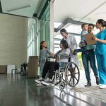 Group of Latin American people arriving at the hospital and talking to doctors